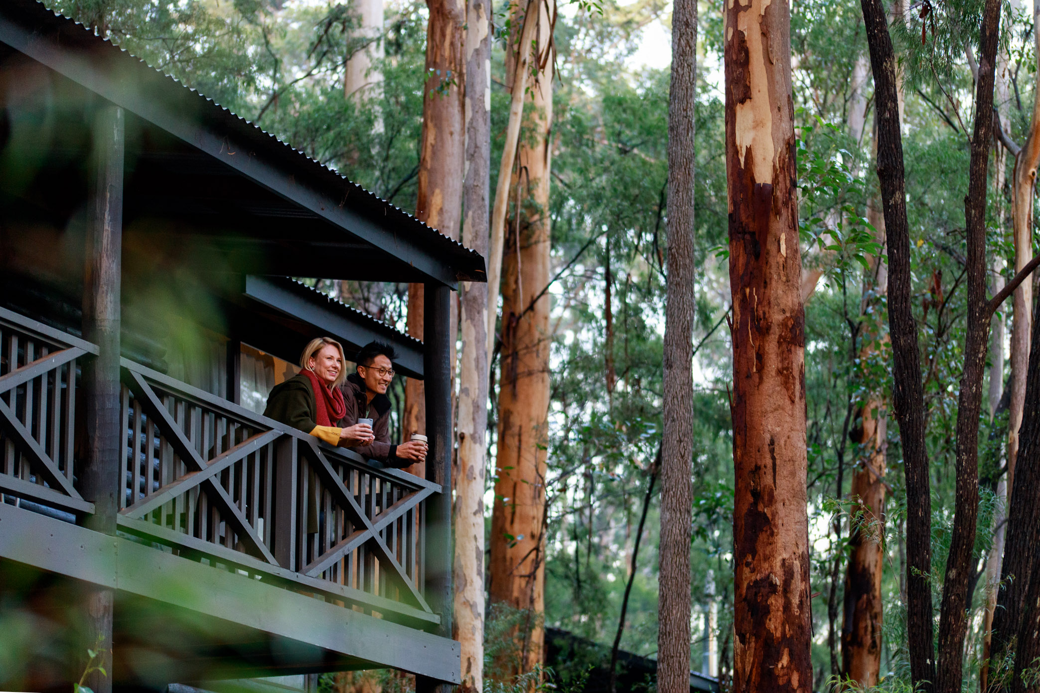 A couple overlooking RAC Karri Valley Resort from their balcony