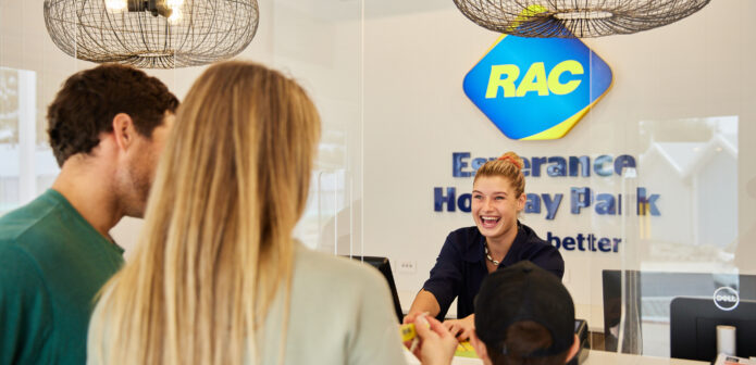 A friendly receptionist helping customers at RAC Esperance Holiday Park