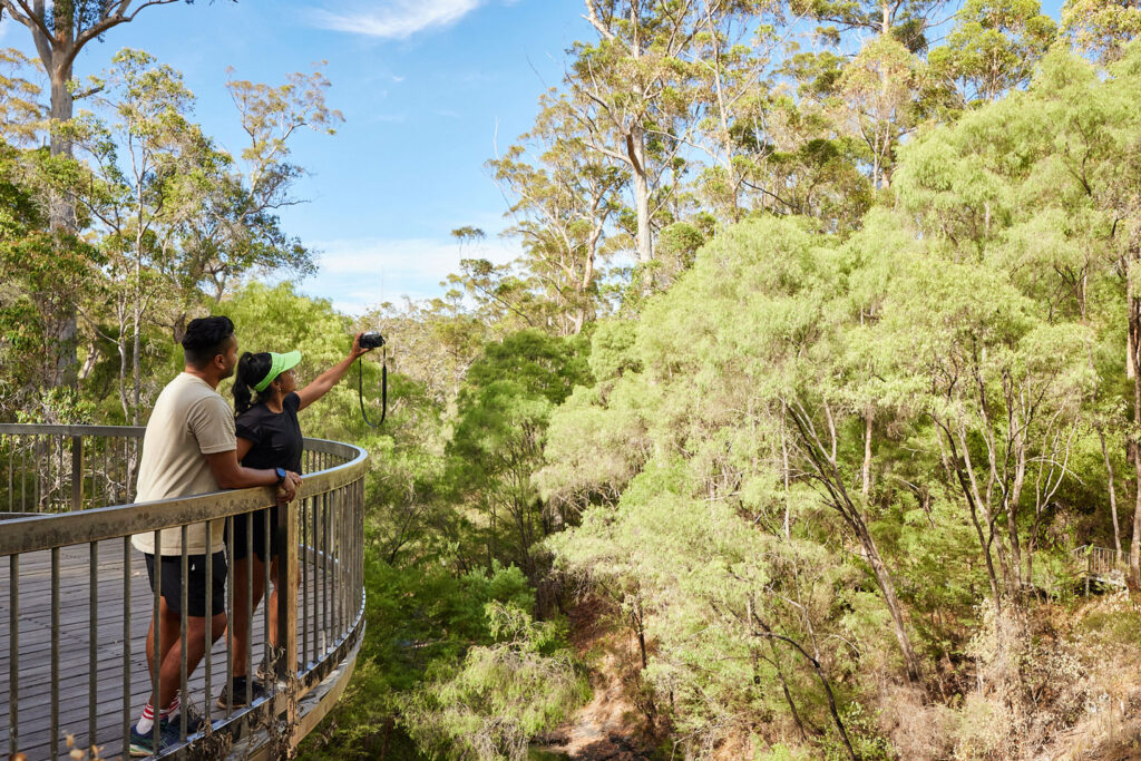 Young couple take a selfie at the lookout point at Beedelup Falls