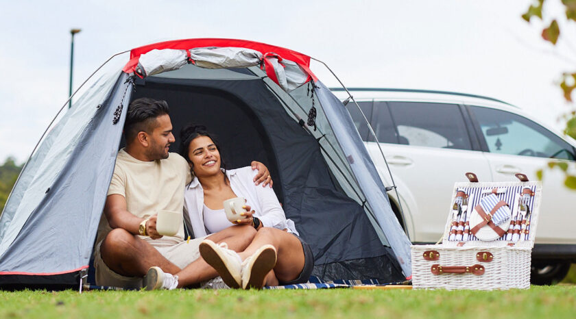 Young couple relax in tent at the campgrounds of RAC Karri Valley Resort.