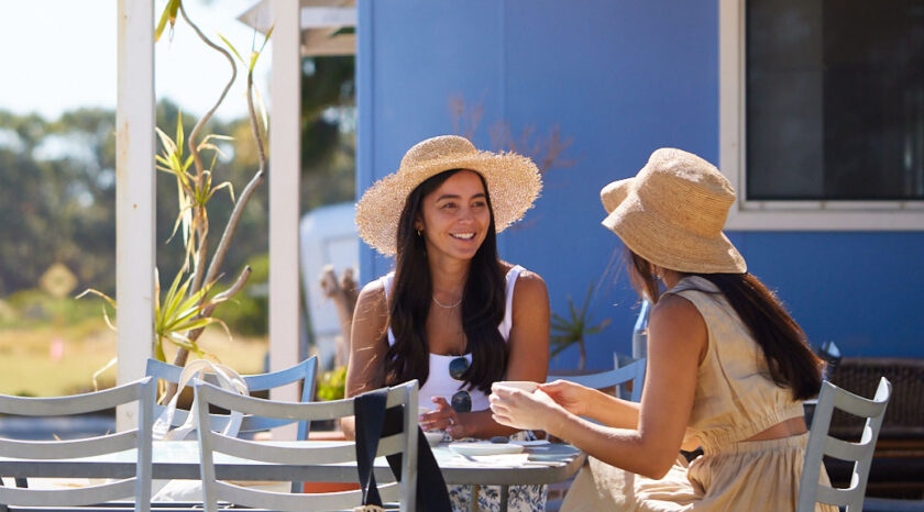 Two people enjoy breakfast at Seashells Cafe, Cervantes