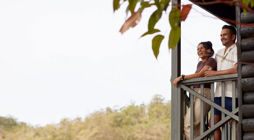 Couple on balcony overlooking the lake at Karri Valley