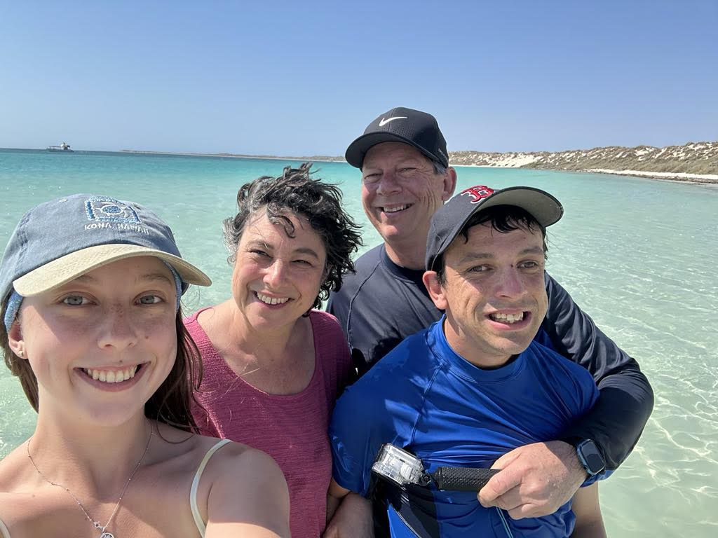 The Jones family of four selfie in the blue waters of the beach in Monkey Mia, Western Australia.