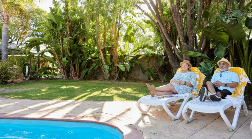 Couple relaxing by RAC Busselton Holiday Park pool