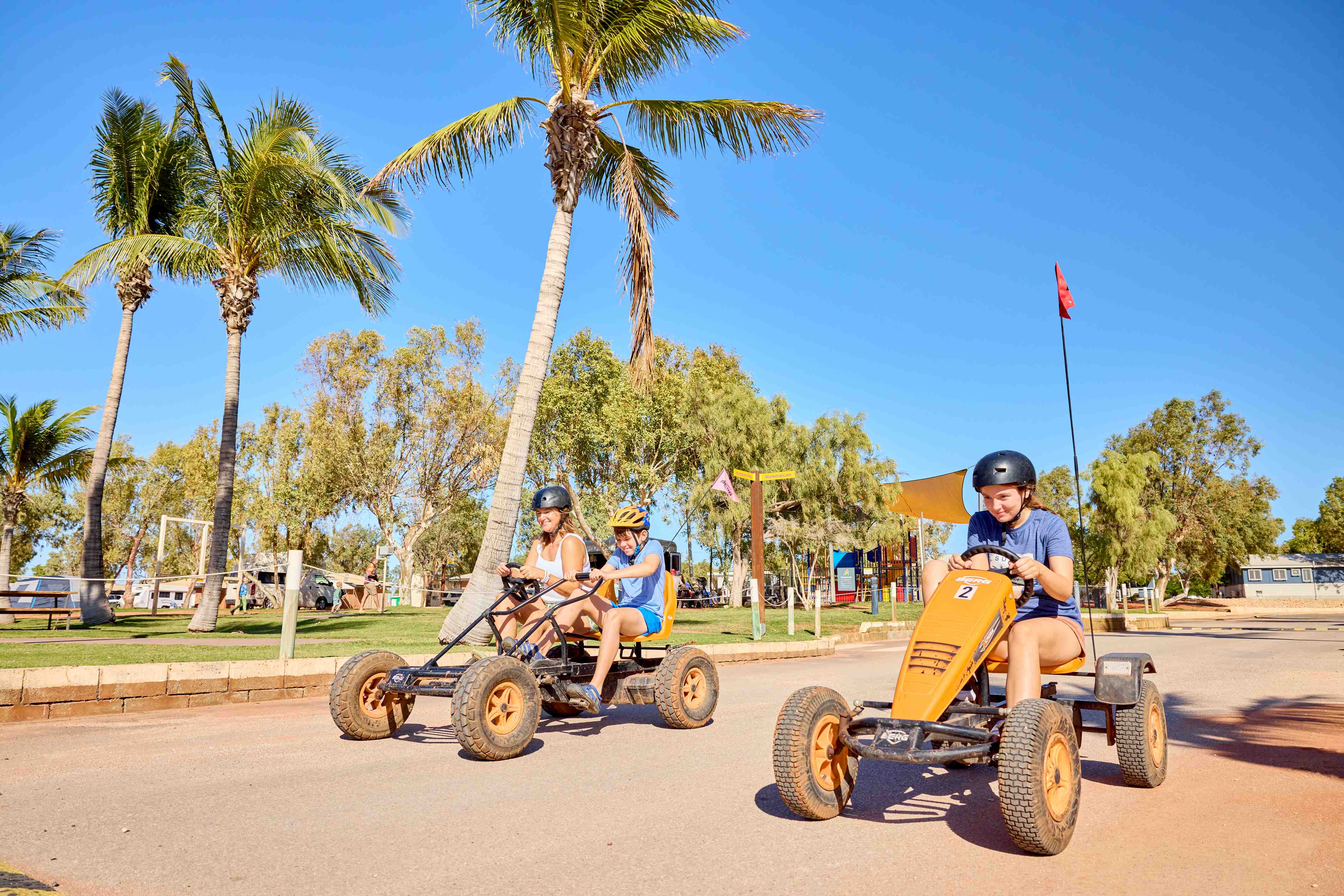 A family riding pedal karts around the Exmouth park.